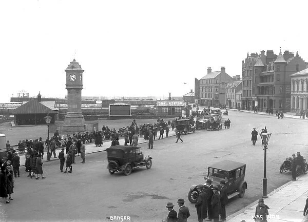 Bangor - an elevated view of the McKee clock and Quay street, there are people sitting
