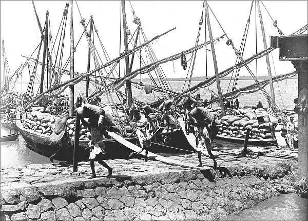 Natives unloading cargo from boats