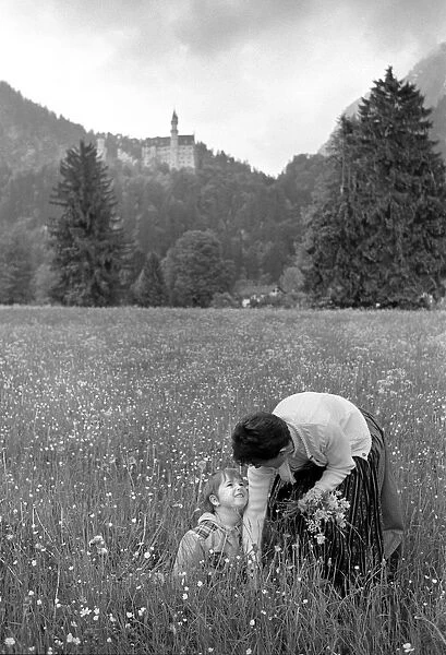 Picking flowers below Ludwigs Castle, Fussen, Bavaria