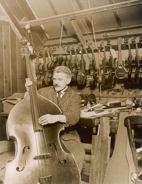 Stringed instrument maker in his workshop
