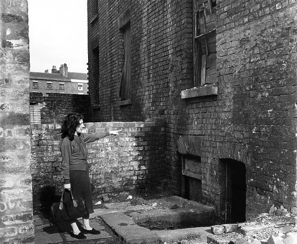 Woman and Liverpool derelict house