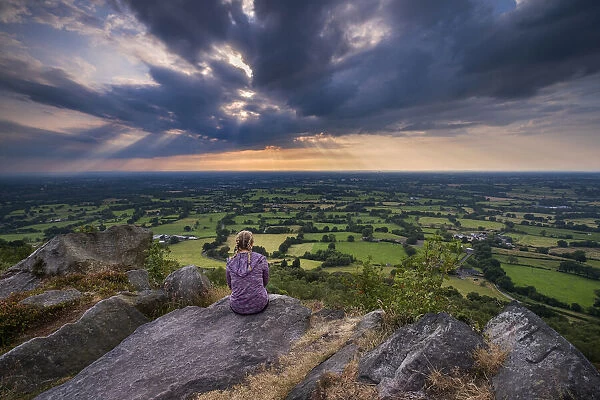 A girl looks out over the Cheshire Plain from Bosley Cloud, Cheshire, England, United Kingdom, Europe