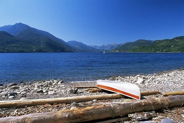 Upturned canoe on the rocky eastern shore of Slocan Lake, New Denver, British Columbia (B