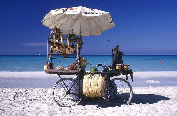 20045651. CUBA Varadero Beach vendors stall on a bicycle selling musical instruments