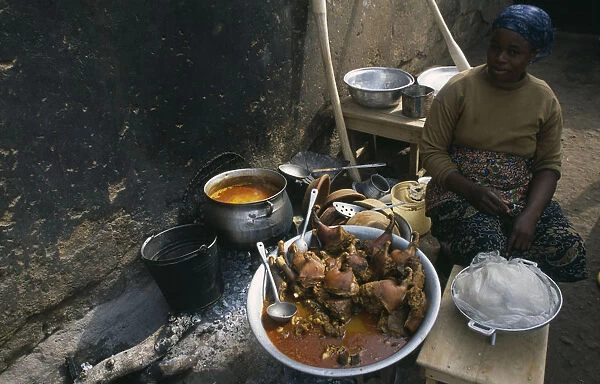 20075482. GHANA Central Food Woman selling stew of guinea-fowl at street food stall