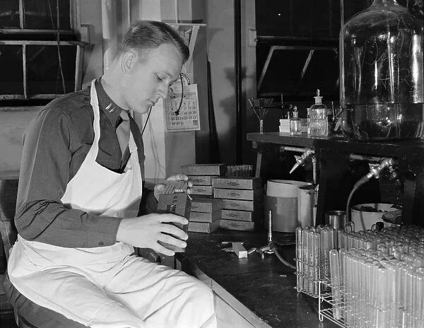 U. S. ARMY LABORATORY, 1943. U. S. Army Captain examining the contents of a K ration