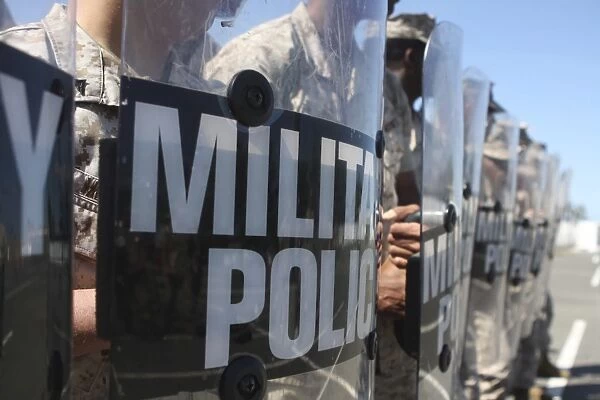 A close-up view of Marines holding riot control shields