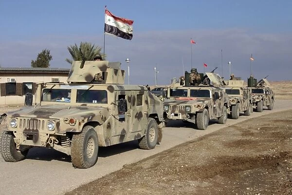 Iraqi Army soldiers aboard M1114 humvee vehicles