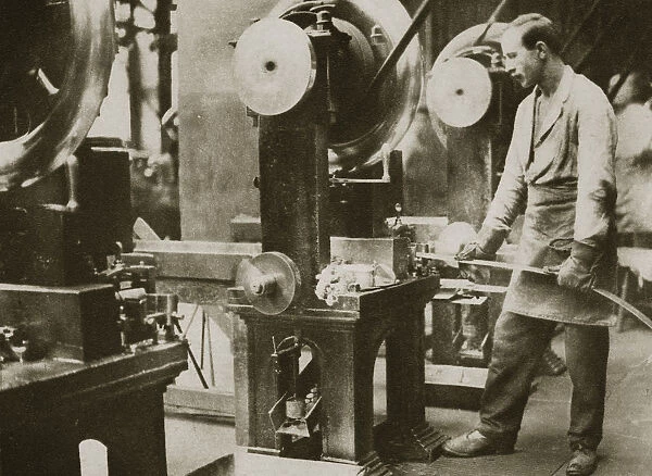 Money making; cutting strips of silver into disks, 20th century