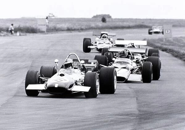 1969 British Grand Prix. Silverstone, Great Britain. 19 July 1969. Piers Courage, Brabham BT26-Ford, 5th position, leads Graham Hill, Lotus 49B-Ford, 7th position, and Chris Amon, #11 Ferrari 312, retired