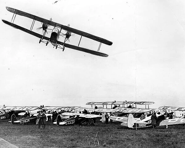 A Handley Page W-8 banks over the parked aircraft at Cramlington airfield