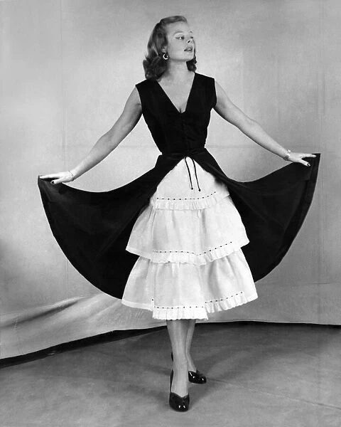 A model in a petticoat dress. December 1951