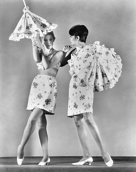 Two models wearing underwear and holding umbrellas. February 1967 P018256