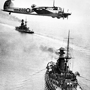 Avro Anson flying over HMS Revenge, WW2