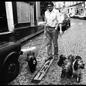 Man with 3 dogs in Paris Street