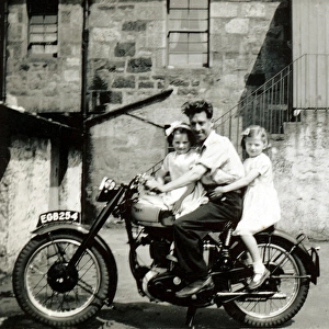 Man and two little girls on BSA Gold Star motorcycle