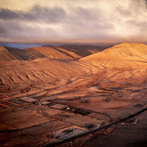 Aerial view of sunrise over the dry desert land of Caldereta, Vallebron, La Oliva