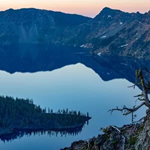 Wizard Island and the still waters of Crater Lake at dawn, the deepest lake in the U