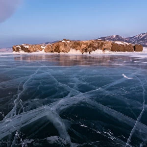 A flat ice with cracks of the lake Baikal, Cape Uyuga, Irkutsk region, Siberia, Russia