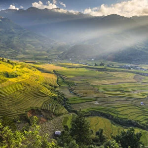 Sun beams over the mountains surrounding the rice terraces at Tu Le, Yen Bai Province