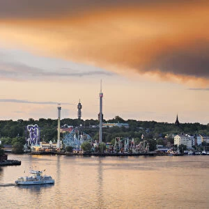 Sweden, Stockholm, Grona Lund Tivoli, passenger ferry in bay at dusk