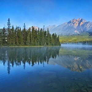 Canada, Alberta, Jasper National Park. Mountain and forest reflections in lake
