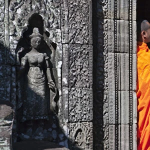 Monk with Buddhist statues in Banteay Kdei, UNESCO World Heritage site
