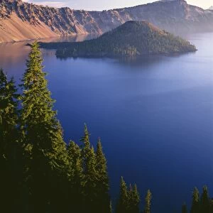 USA, Oregon, Crater Lake National Park. Sunrise on west rim of Crater Lake with Wizard Island