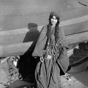 BEDOUIN WOMAN, c1910. Portrait of a Bedouin woman outside her tent in the Middle East