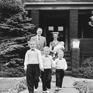 Family portrait in front of house, 1957