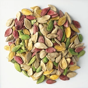 Red, green, yellow and beige pumpkin seeds