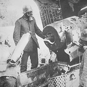 WWI German gunners load poison gas shell wearing gas masks on the Western Front