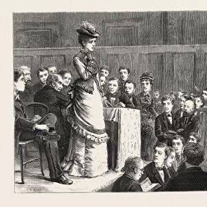 A SPELLING BEE: A FAIR COMPETITOR PUZZLED. ENGRAVING 1876, UK, britain, british, europe