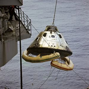 The Apollo 9 Command Module is hoisted aboard the recovery ship