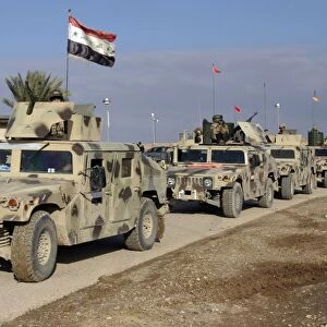 Iraqi Army soldiers aboard M1114 humvee vehicles