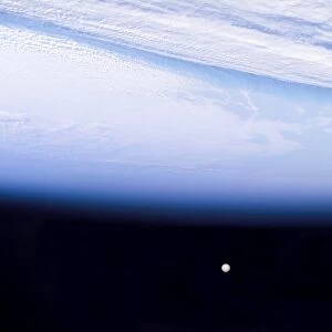 A full moon above Earthas horizon and airglow