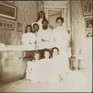 Grigory Rasputin with Empress Alexandra Fyodorovna, her five children and seated right governess Mar