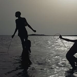 Silhouette Of Boys Fishing