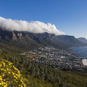 View of Cape Town Skyline and Camps Bay with clouds over the Twelve Apostles Mountains, South Africa
