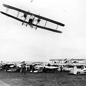 A Handley Page W-8 banks over the parked aircraft at Cramlington airfield