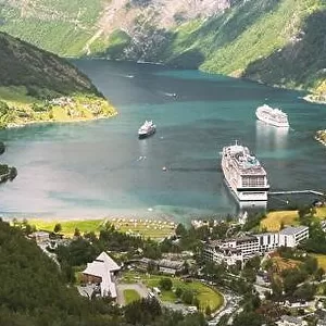 Geiranger, Geirangerfjord, Norway - June 18, 2019: Touristic Ship Ferry Boat Liner Moored Near Geiranger. Famous Norwegian Landmark And Popular Destin